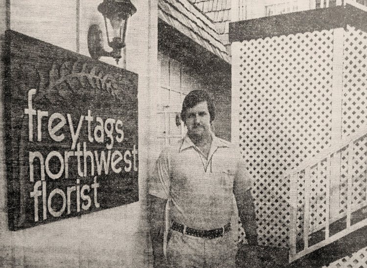 Photographed some time in the 1980s, Ken Freytag poses beside the sign outside his Texas flower shop